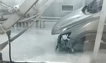 Car bodies enter the electrophoretic coating tank for E-coating application